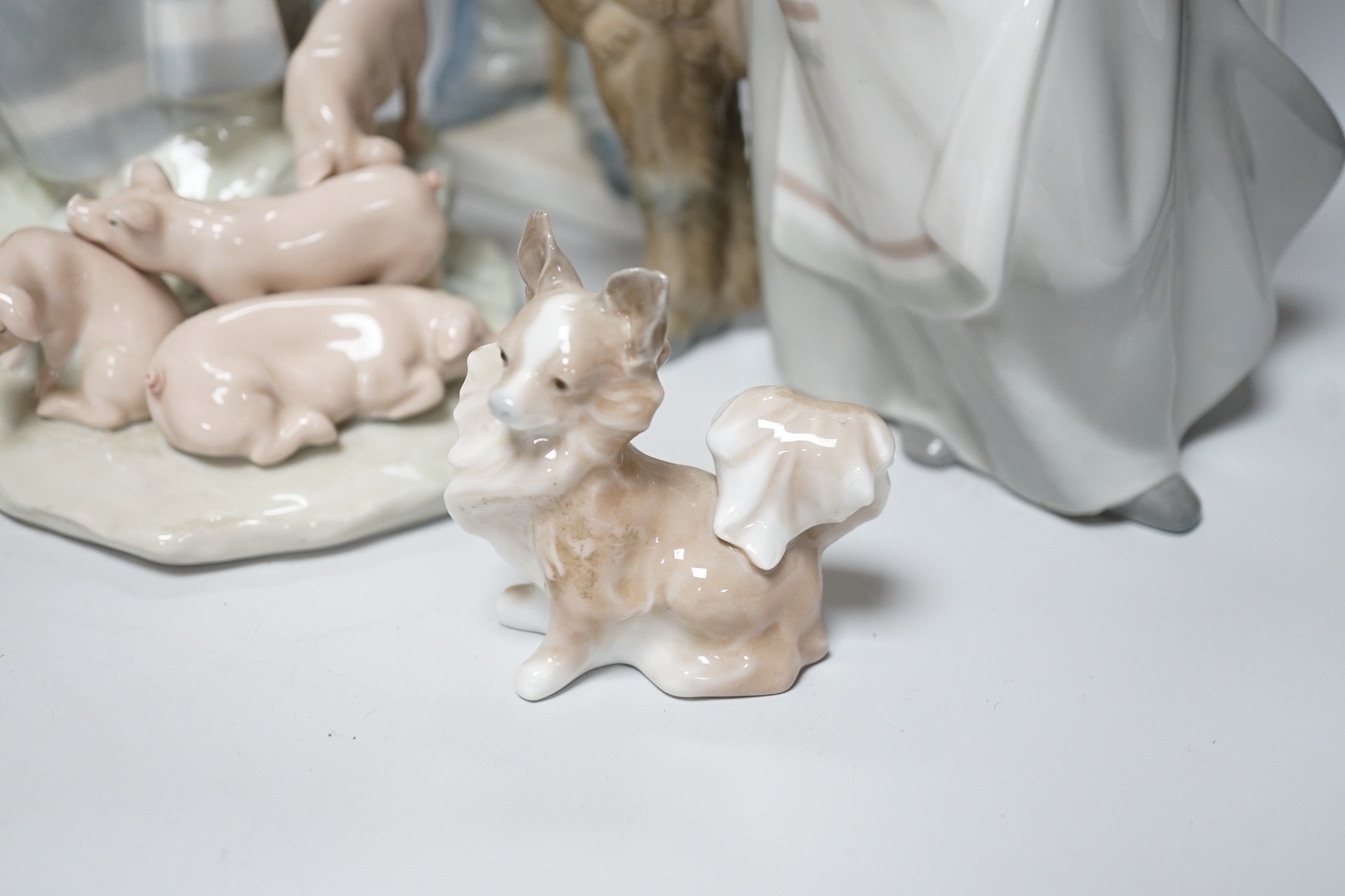 A collection of nine Lladro porcelain figures, tallest 36cm